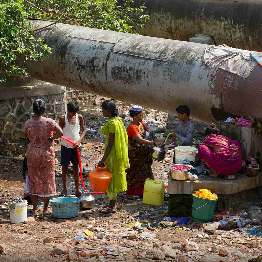 Families living in slums drawing water from dirty water sources
