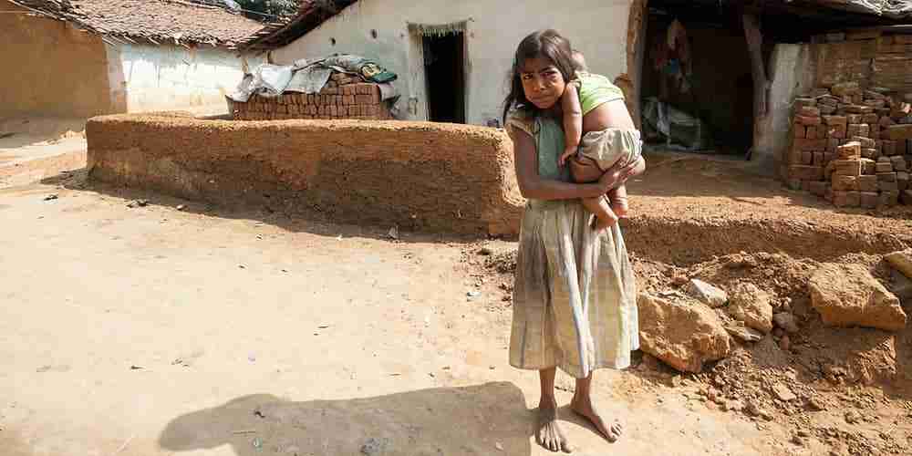 Girl and her younger sibling in poverty in Asia
