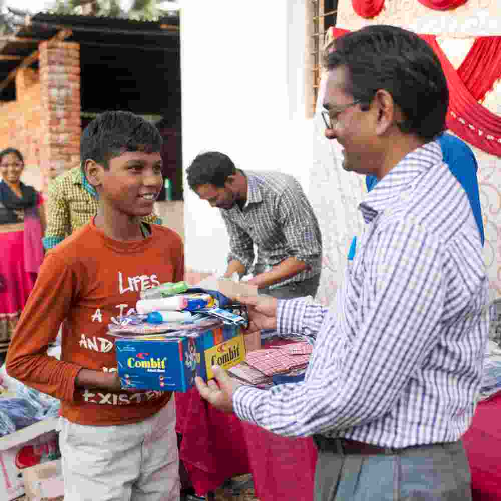 Young boy receives school supplies from GFA World Bridge of Hope special event