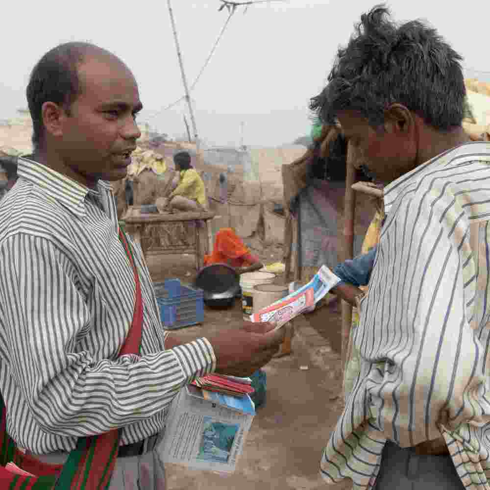 GFA World national missionary worker ministering to a man in poverty