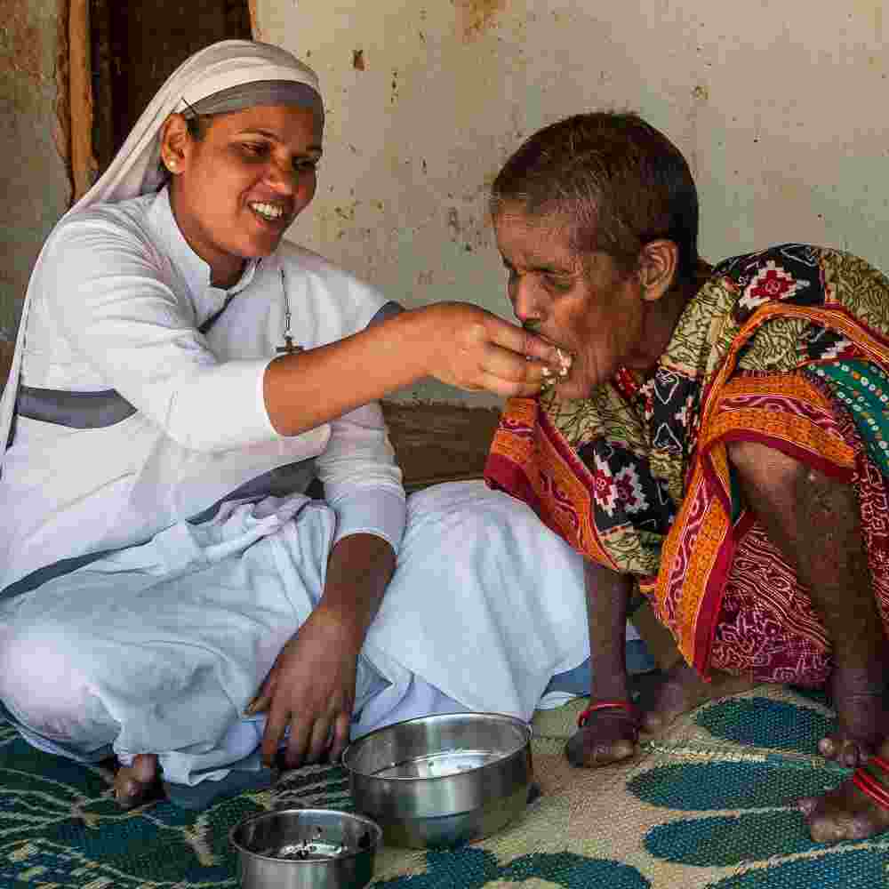 Sisters of Compassion cook food and feed this leprosy patient by hand in this regular bi-weekly visits.