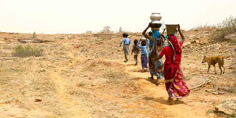 Family walks long distances to acquire water due to water stress in their region