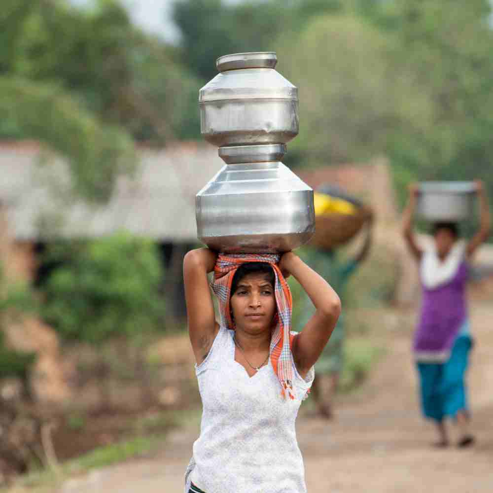 A woman walks over two kilometers to fetch water from a water well