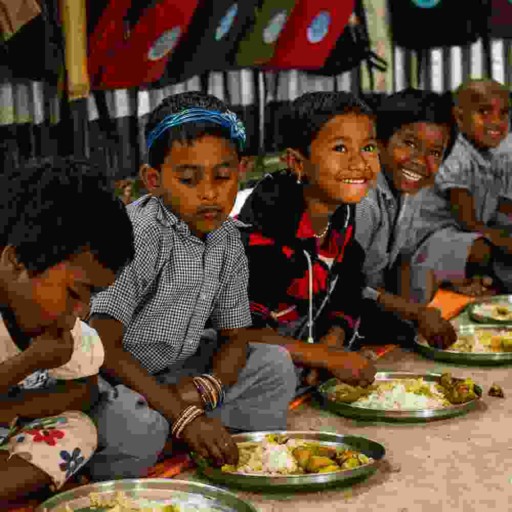 Children in GFA World child sponsorship program eating nutritious food