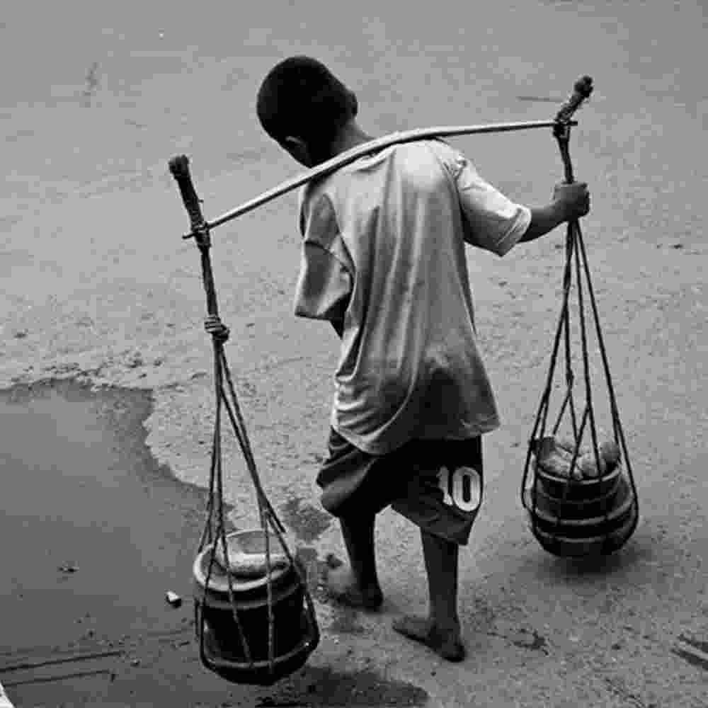 Child labor in Indonesia, selling cooking tools on the street.