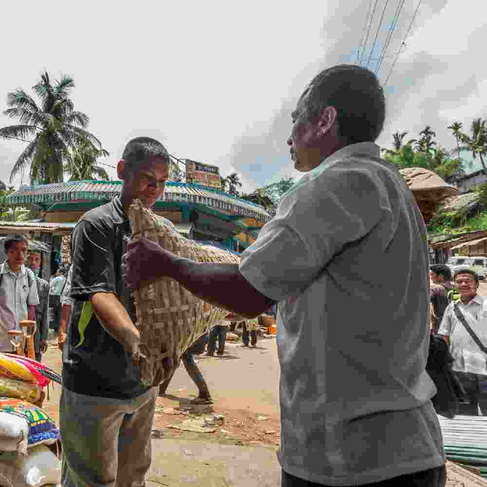 Man receives an income generating gift of a pig from GFA World gift distribution