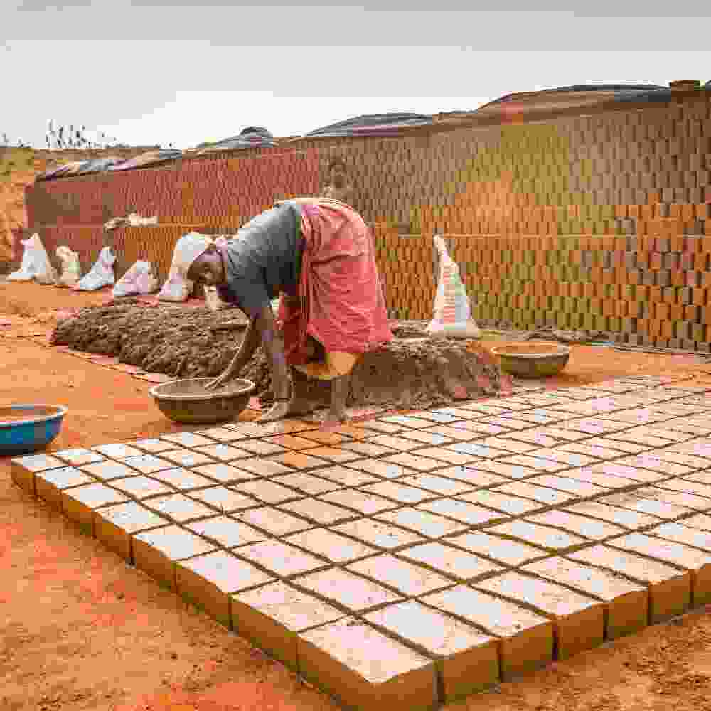 Woman in poverty working in a brick factory