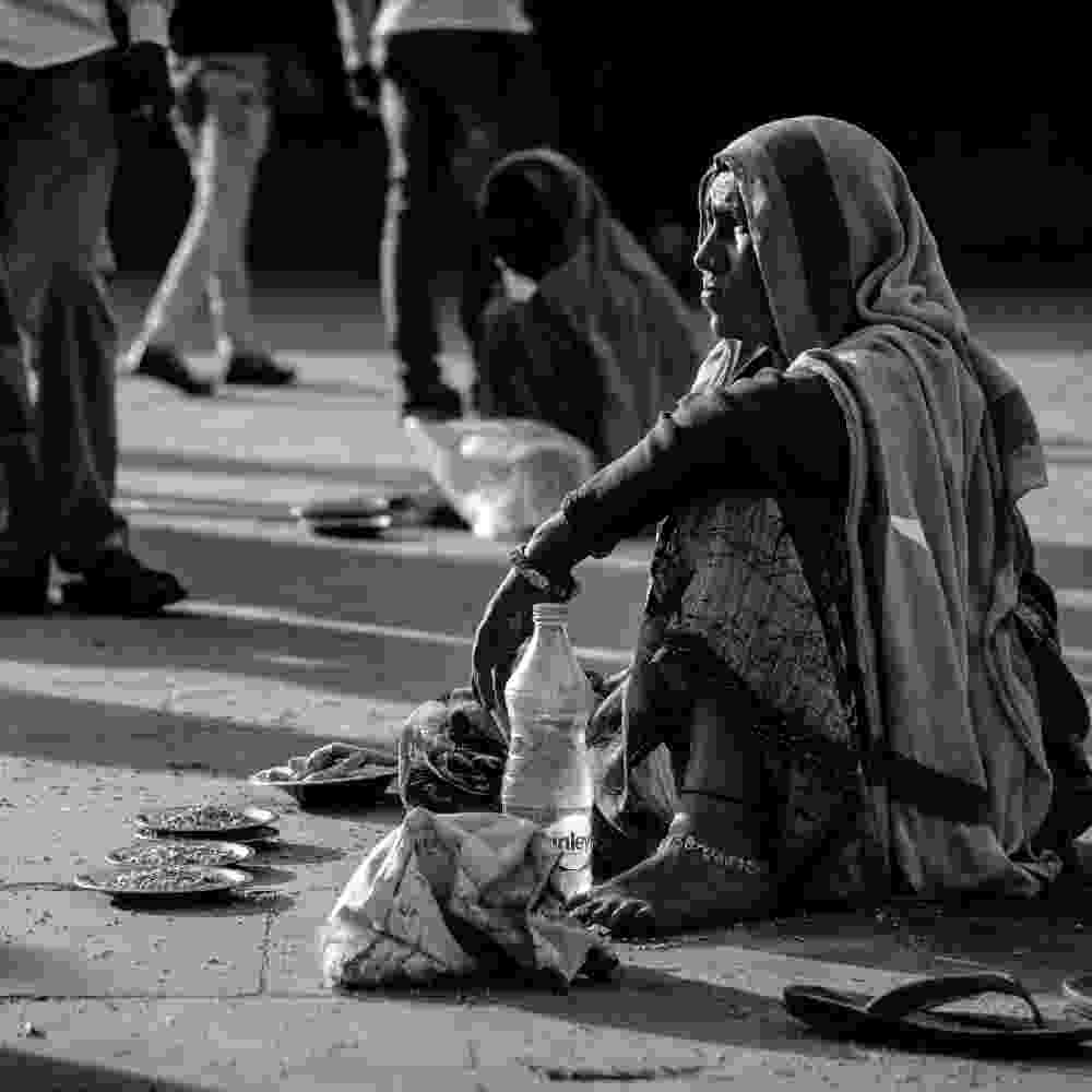 Woman in poverty begging on the street