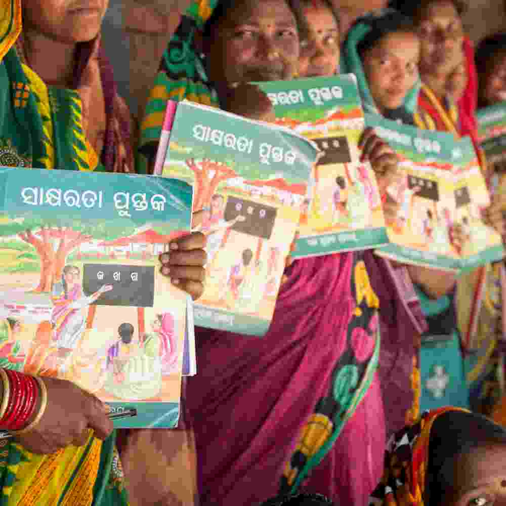 Group of women and their workbooks from GFA World adult literacy class