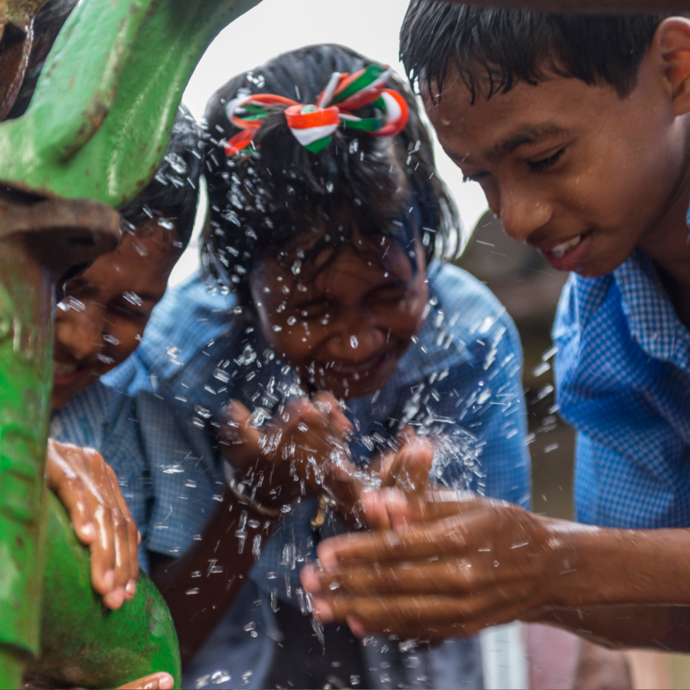 Children happily enjoying clean water through GFA World Jesus Wells