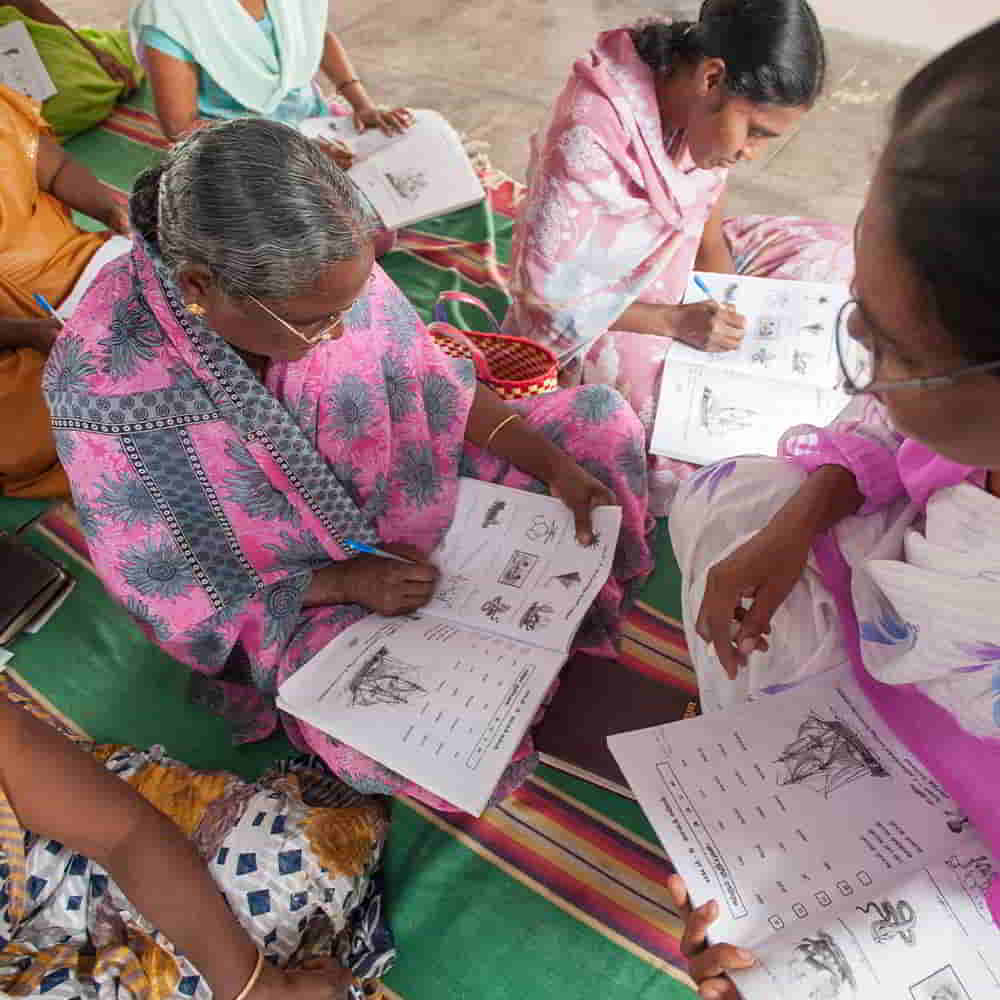Women receiving instruction in GFA World adult literacy class