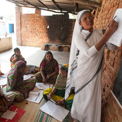 Woman missionary teaching in GFA World adult literacy class