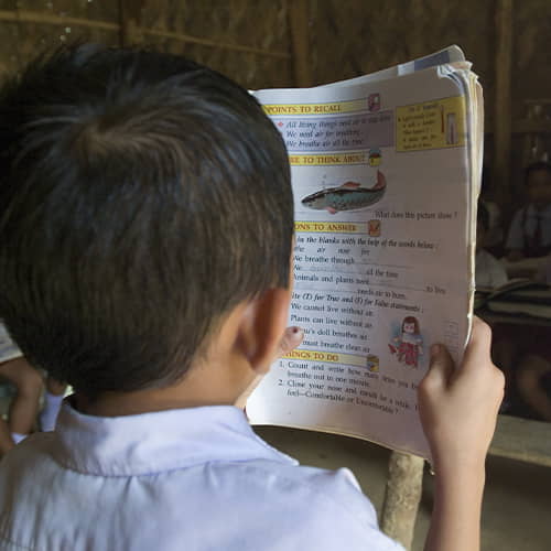Young boy reading his workbook in GFA World child sponsorship