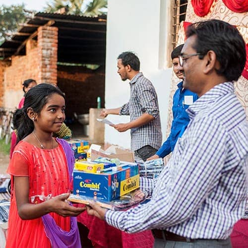 Ashima receives a gift of school supplies from GFA World child sponsorship program