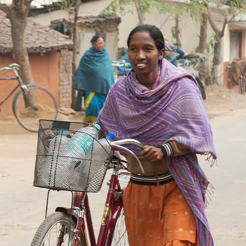 GFA World woman missionary and her bicycle