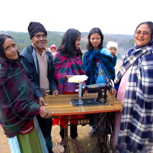 Family in poverty receives an income generating tool of a sewing machine through GFA World gift distribution