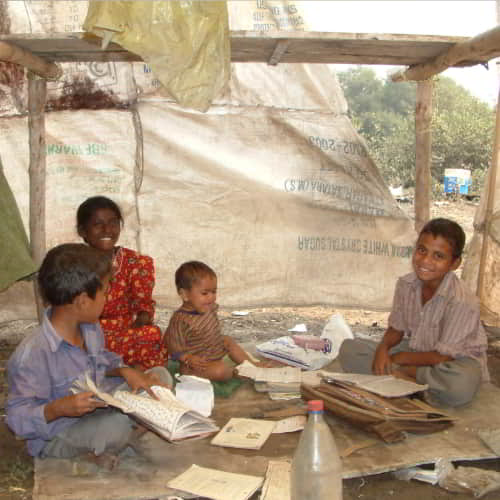 Children in poverty struggling to study in a slum in South Asia