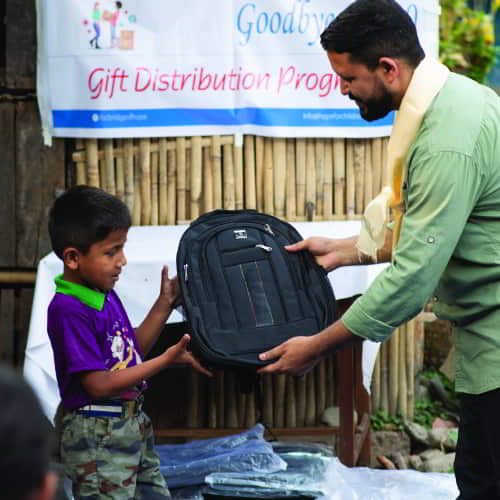 Child receiving school supplies through GFA World Child Sponsorship gift distribution