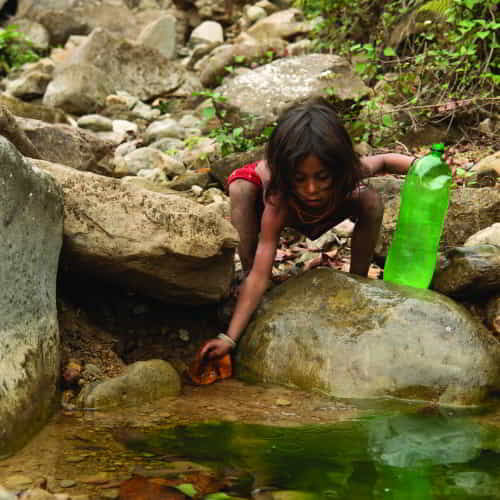Child collecting water from a contaminated source.