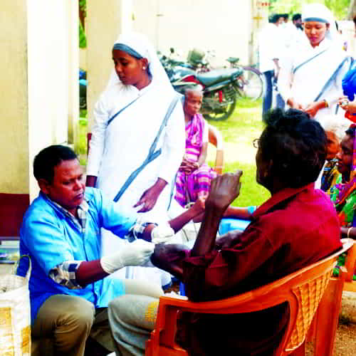 GFA-supported workers providing medical aid, including wound cleaning and medication provision, to leprosy patients