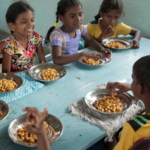 Children eat nutritious food through GFA World child sponsorship