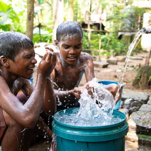Children enjoying clean water through Jesus Wells, one of the types of water wells GFA World provides