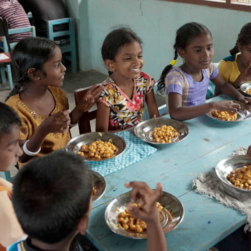 These girls enjoy a daily nutritious meal through GFA World child sponsorship program