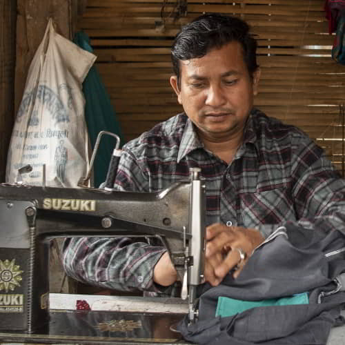 Man escapes the effect of poverty and unemployment through GFA World income generating tool of a sewing machine