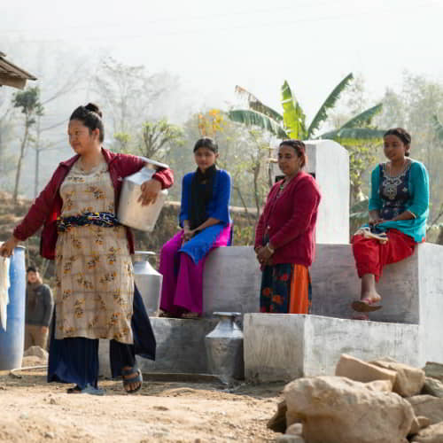 Women draw clean water through clean water solutions like GFA World Jesus Wells
