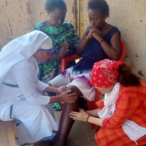 GFA World women national missionaries shares the love of Jesus to a sick woman in poverty