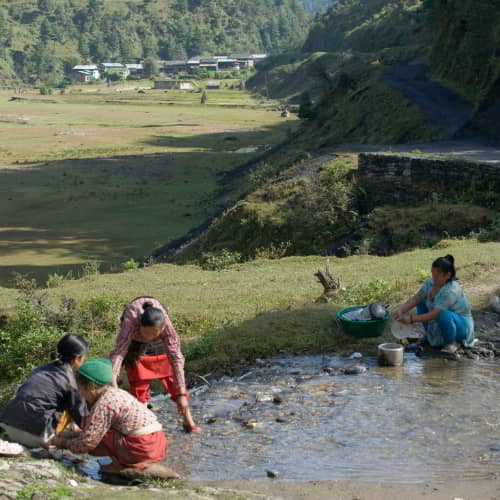 Village community making use of impure water due to their dependence on an open water source