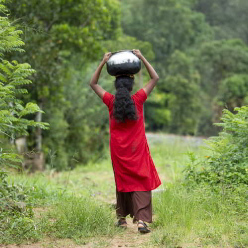 Women and children walk long distances to acquire water that is often contaminated