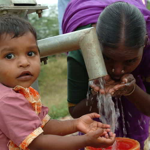 Mother and child drinks clean water through GFA World Jesus Wells