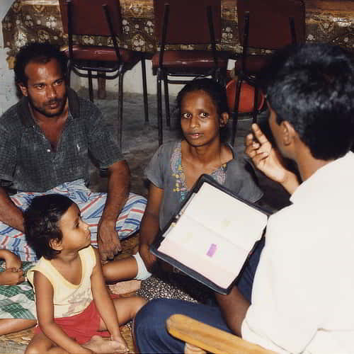 GFA national missionary sharing God's love to a family in a 10/40 window country