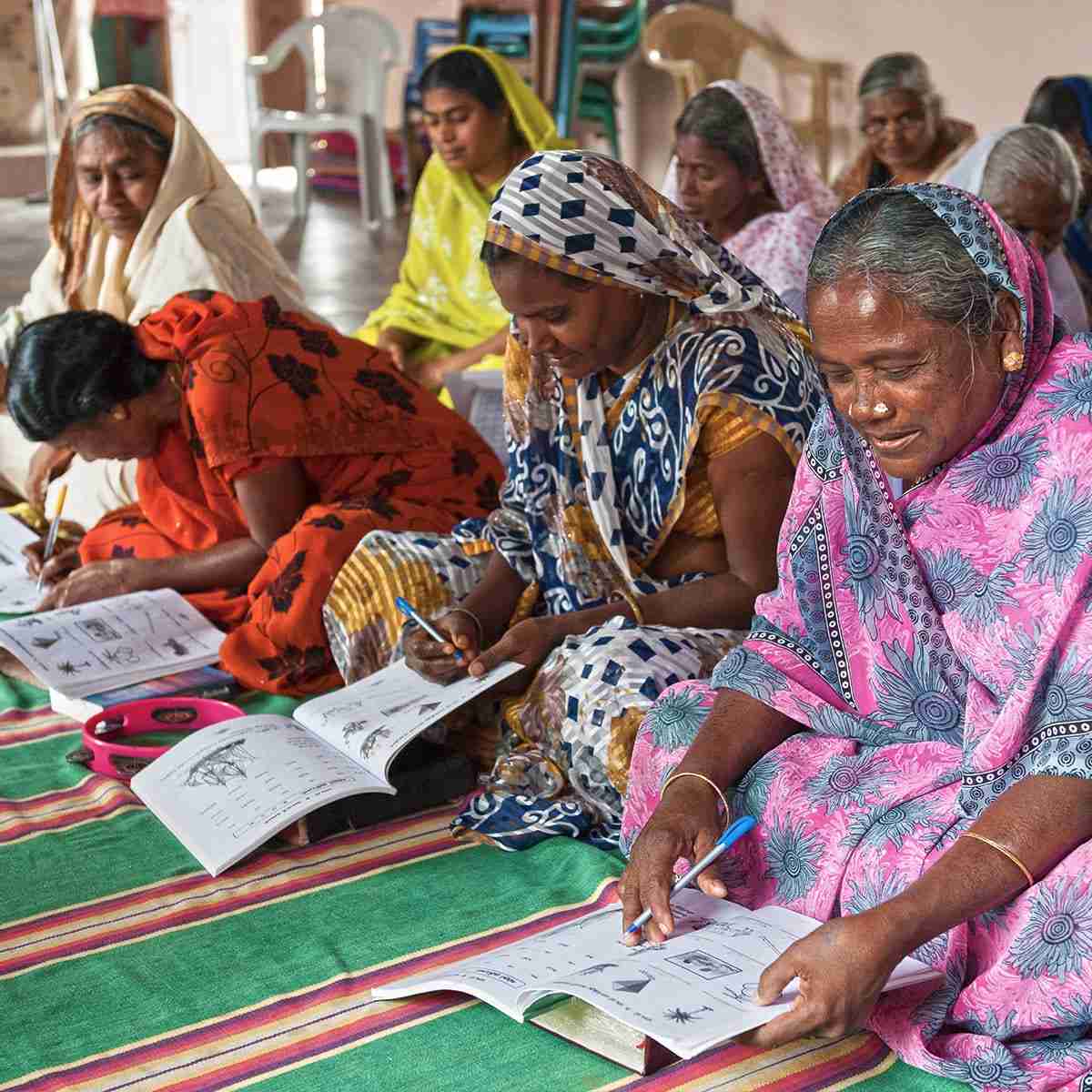Adult women learning how to read and write in GFA World Literacy Class