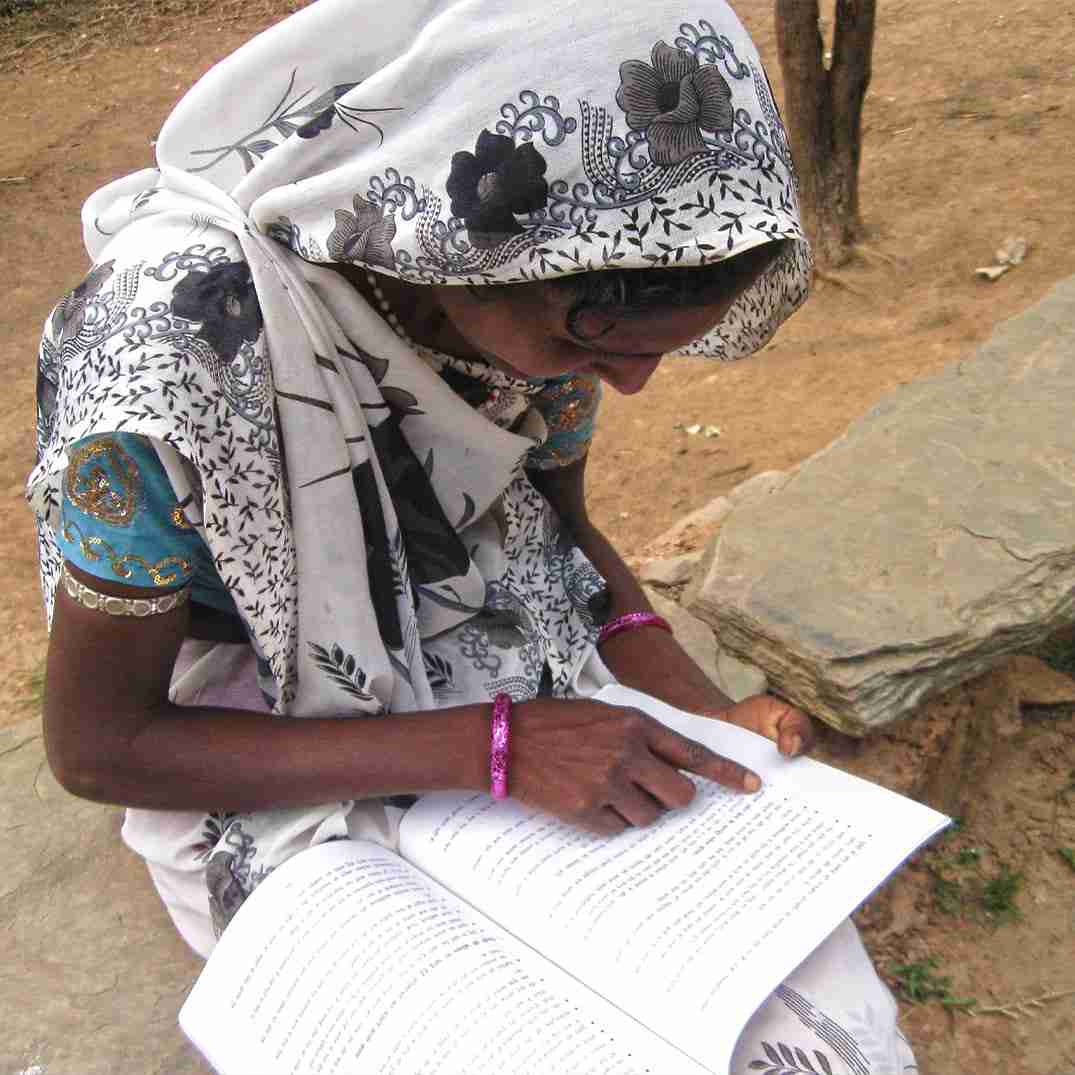 Woman reading adult literacy book