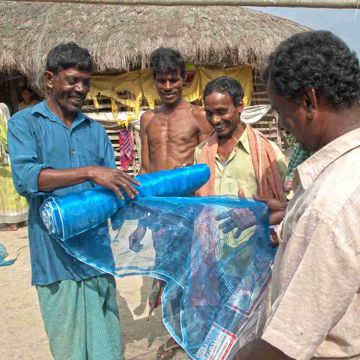 Man receives fishing net from GFA World Christmas gift distribution