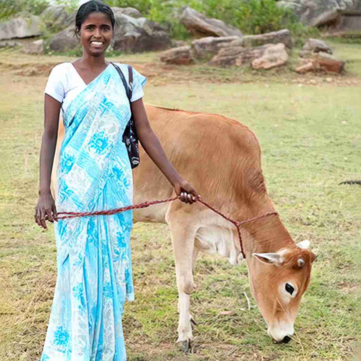 A woman and the cow her family received at a GFA World gift distribution