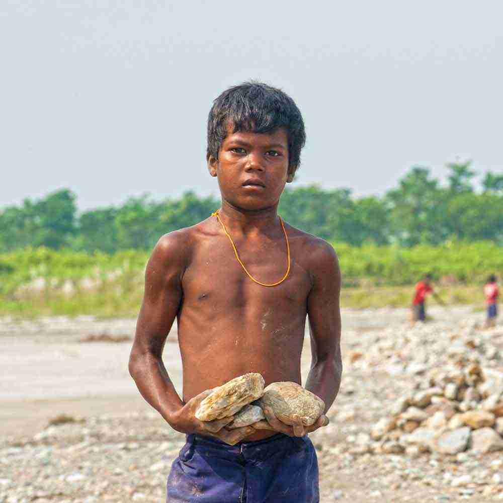 Young boy compelled to child labor in order to survive and endure poverty
