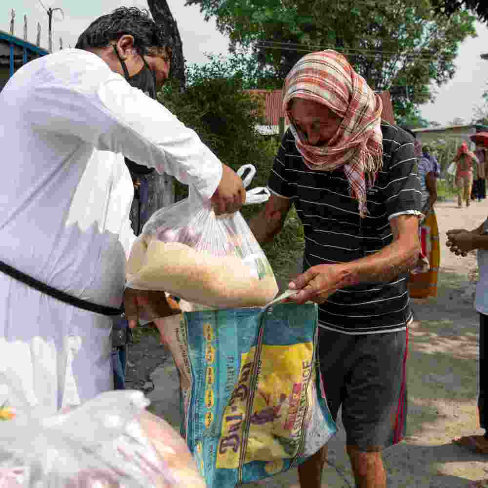 GFA World national missionaries distributing food relief packets to the poor