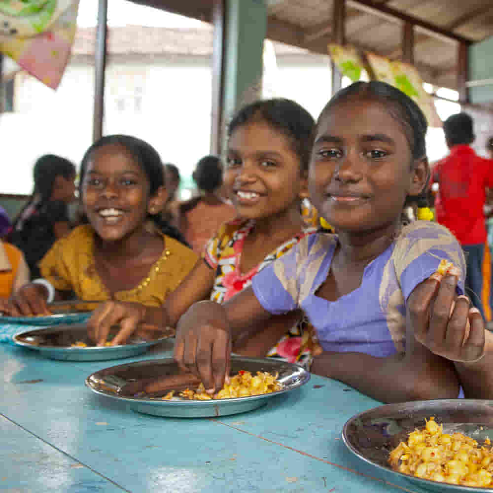 Children eat nutritious food through GFA World child sponsorship Bridge of Hope