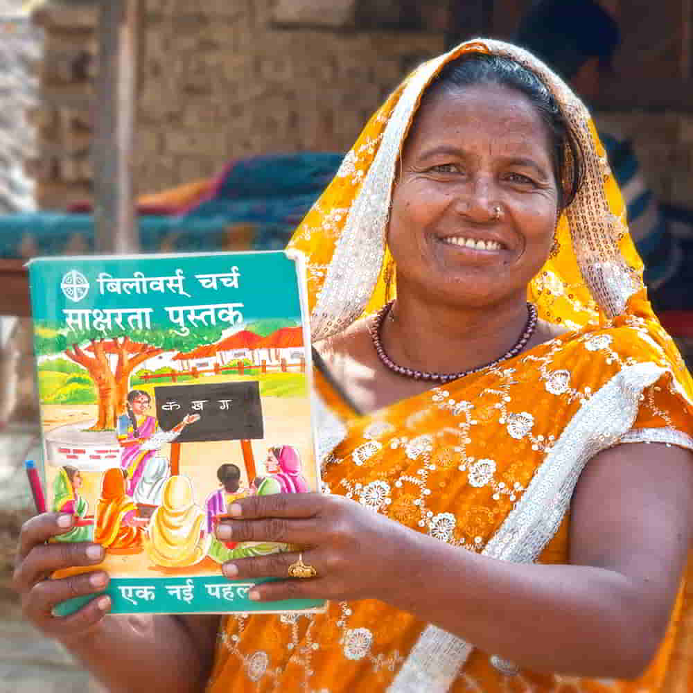 Woman holding adult literacy booklet