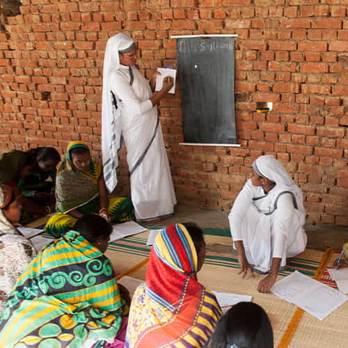 GFA World woman missionary teaches an adult literacy class