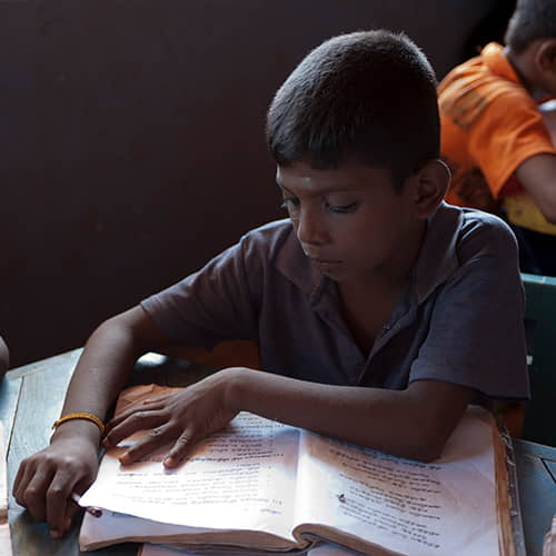Young boy studying in GFA World child sponsorship class