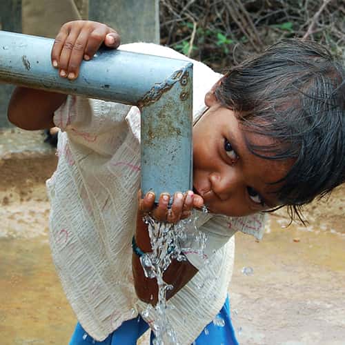 Child drinking clean water through GFA World Jesus Wells