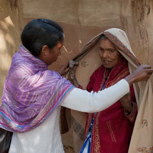 GFA World woman missionary sharing the love of Jesus to a leprosy patient