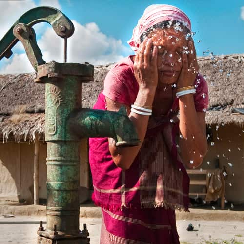 Woman washes up with clean water from GFA World (Gospel for Asia) Jesus Wells