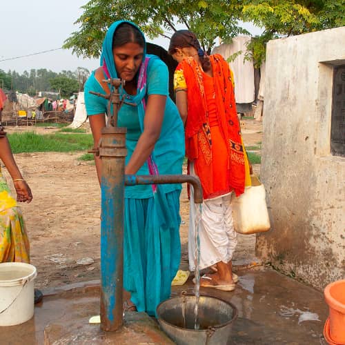 Woman drawing clean water through GFA World (Gospel for Asia) Jesus Wells