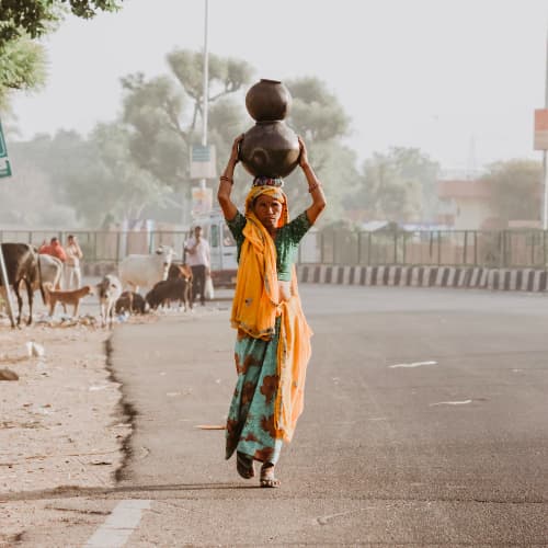 Women and children from South Asia travel long distances to collect water that is often contaminated