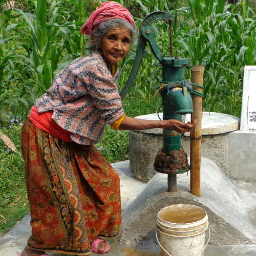 Elderly woman enjoys clean water through GFA World Jesus Wells